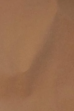 Light brown rough background. Close up 库存照片