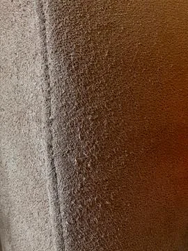 Light brown sofa corner scratched by cat Stock Photos