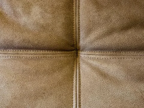 Light brown sofa material close up showing cross stitching and folds Stock Photos