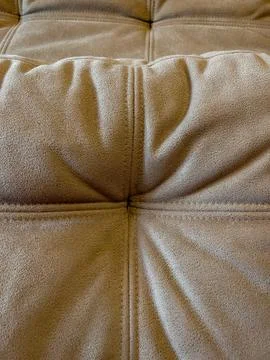 Light brown sofa material close up showing cross stitching and folds Stock Photos