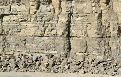 Light brown stone pit wall Stock Photos