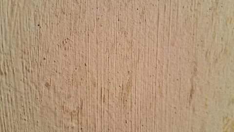 Light brown textured wall surface with vertical plaster brush strokes Stock Photos