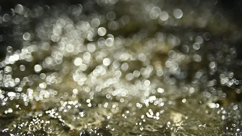 Light bubble bokeh of sunlight reflections on the water (slow motion) Video stock 211746826