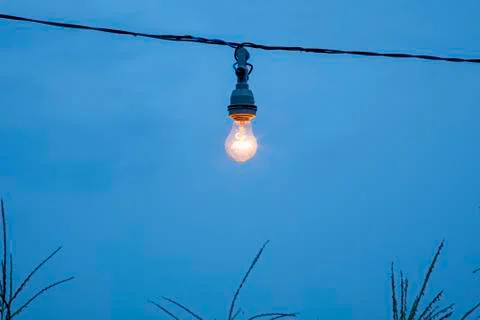 Light bulb accesses with sky as background. Stockfoto's