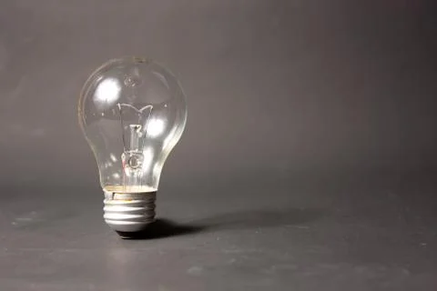 Light bulb alone in black backbround Stock Photos