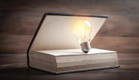 Light bulb and book. Knowledge and wisdom Stock Photos