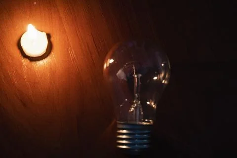 Light bulb and candle Stock Photos