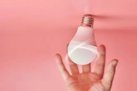 Light bulb and hand, idea catching concept. Symbol of new events or finding s Stock Photos