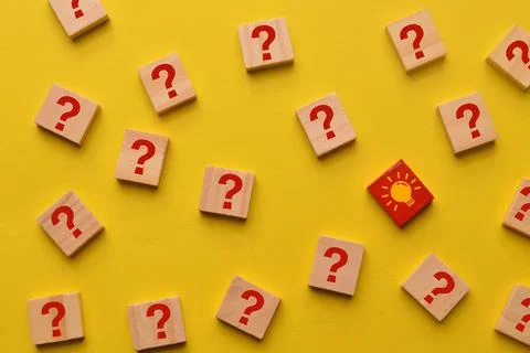 Light bulb and question mark icon drawn on wooden blocks. Stock Photos