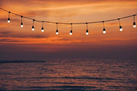 Light bulb on the background of sea sunset Stock Photos