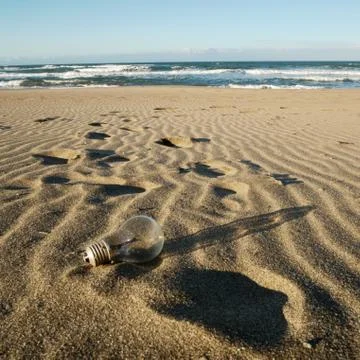 Light bulb on beach Stock Photos