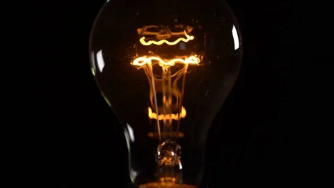 Light bulb on black background Stock Footage 84919614