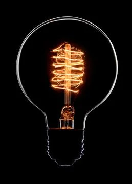 Light bulb on black background Photos