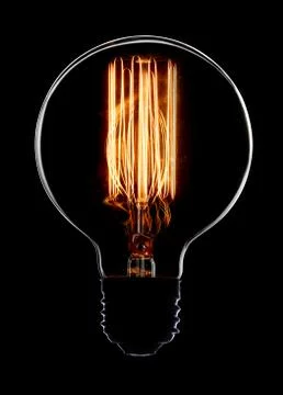 Light bulb on black background Stock Photos