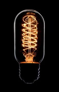 Light bulb on black background Stock Photos