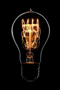 Light bulb on black background Stock Photos