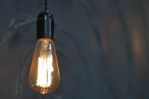 Light bulb on black background Stock Photos