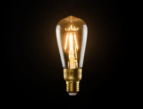 Light bulb on black background Stock Photos