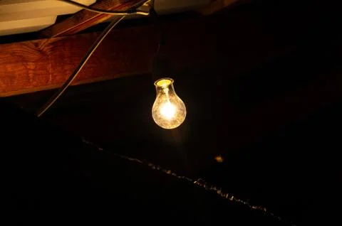 Light bulb on black background Stock Photos