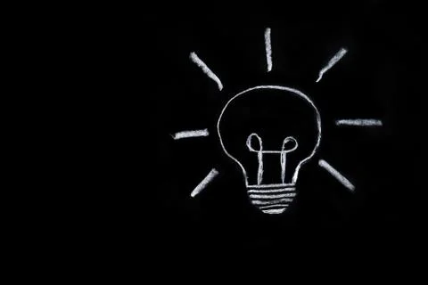 Light bulb on black background Stock Photos