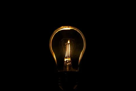Light bulb on a black background Stock Photos