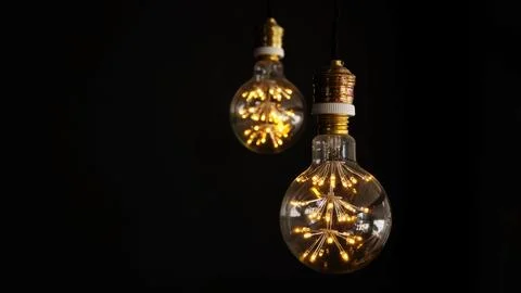 Light bulb on a black background. Stock Photos