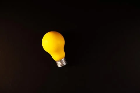 Light bulb with a black background Stock Photos