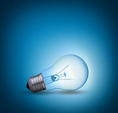 Light bulb on blue background on the ground side Stock Photos