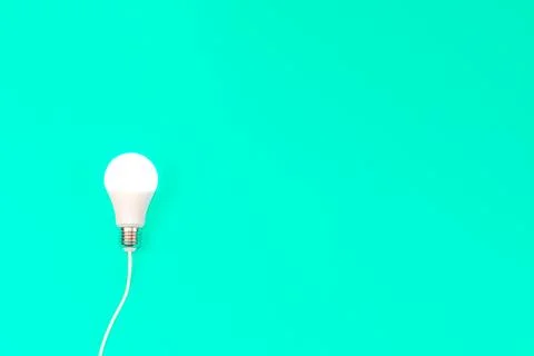 Light bulb in the blue background. Stock Photos