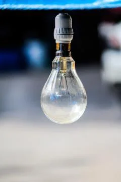 Light bulb on blur background Stock Photos