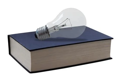 Light bulb on a book representing knowledge and creative ideas on white bac.. Fotos de archivo