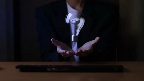 Light bulb with brain inside the hands of the businessman. Stock Footage 220081093