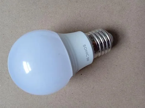 Light bulb on brown background Stock Photos