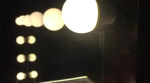 Light Bulb burning and flickering on the mirror with leds Stock Footage 62876490