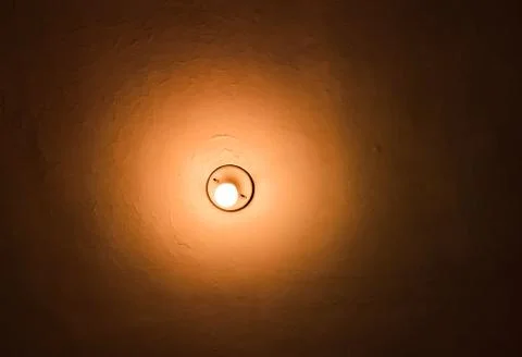 Light bulb in the ceiling, light in darkness concept Stock Photos