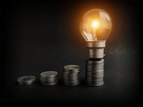 Light bulb with coins stack. Creative ideas for saving money concept. Money Stock Photos