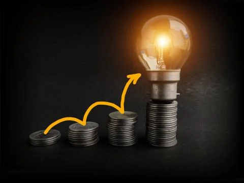 Light bulb with coins stack. Creative ideas for saving money concept. Money Stock Photos