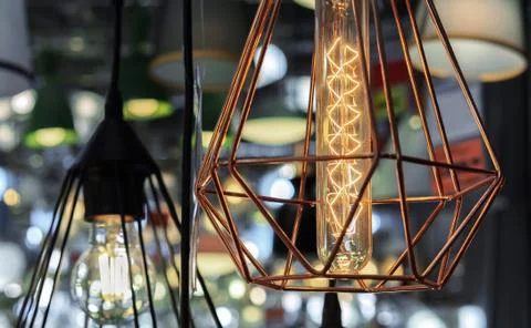Light bulb in a copper wire plaphond. Light bulb in vintage style. Stock Photos