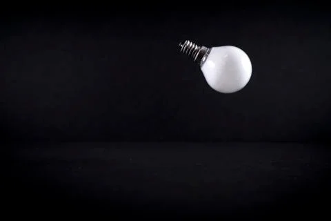 A light bulb on a dark background. Stock Photos