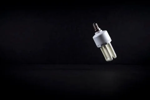 A light bulb on a dark background. Stock Photos