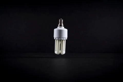 A light bulb on a dark background. Stock Photos