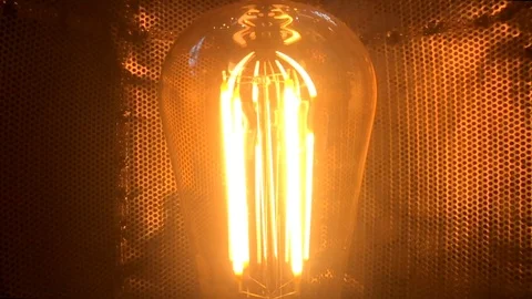A Light Bulb in the dark flickering in slowmotion Stock Footage 103134080