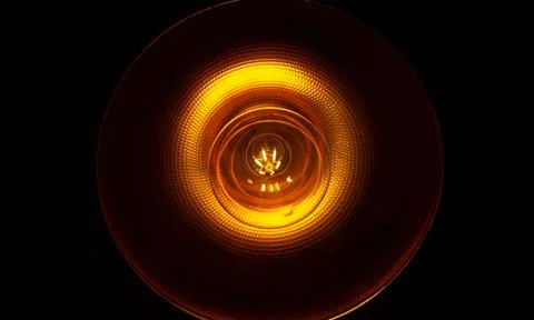 Light bulb in the dark, light bulb on black background Photos