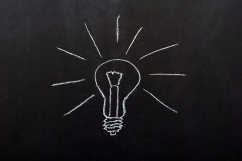 Light bulb drawn on blackboard Stock Photos