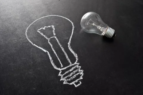 Light bulb drawn on chalkboard Stock Photos
