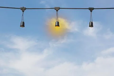 Light bulb on electric cable line Stock Photos