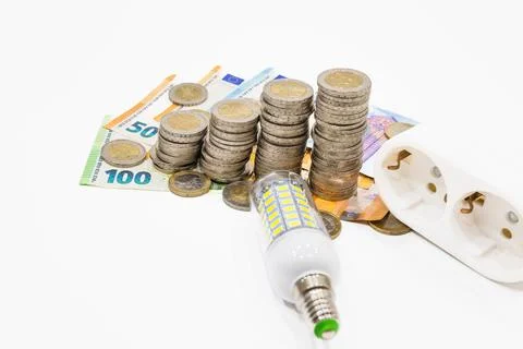 Light bulb, electric plug, and the euro money banknotes. Increasing energy costs Stock Photos