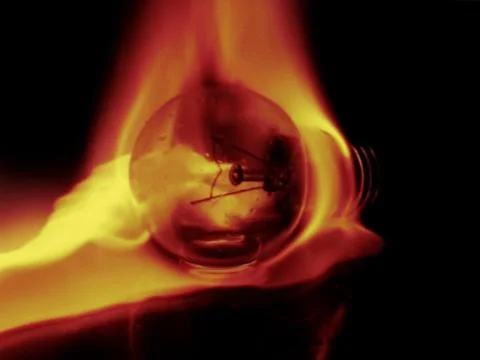 Light bulb in flames Stock Photos
