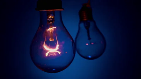 Light Bulb Flashes on a Blue Background in the Dark Stock Footage 236107530