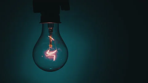 Light Bulb Flashes on a Blue Background in the Dark Stock Footage 236635386